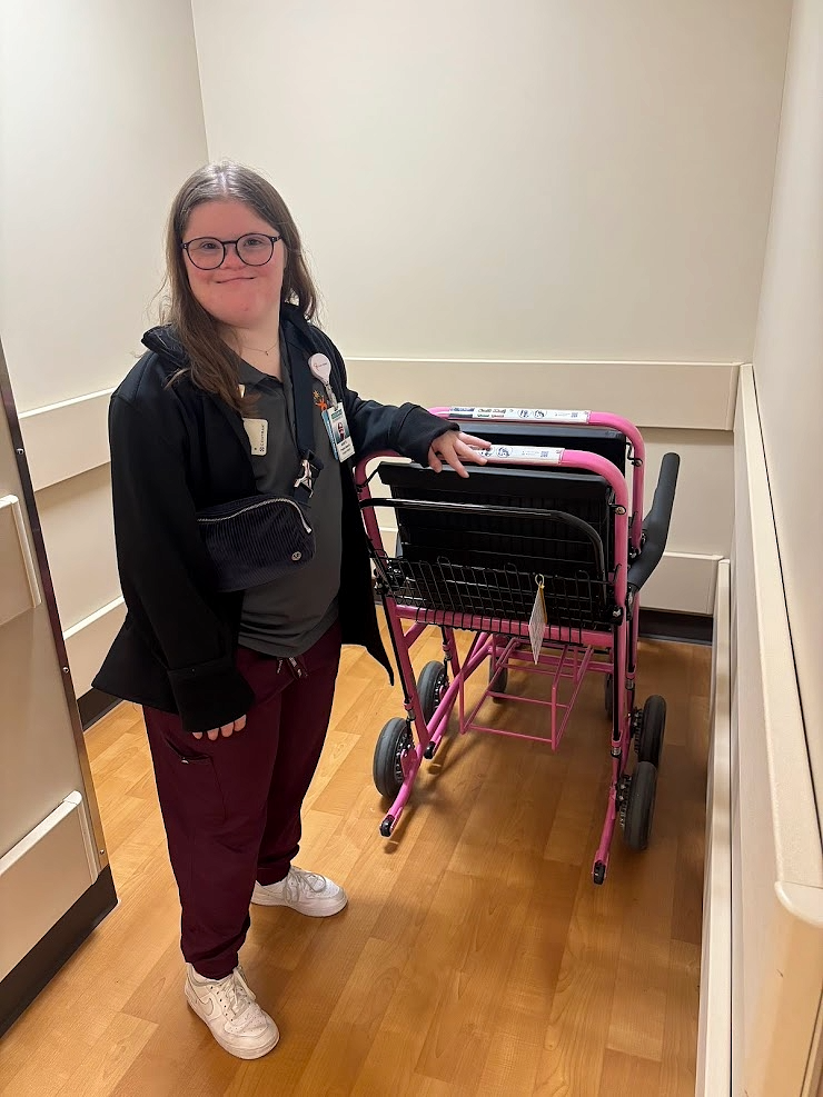 An intern assisting with a wheelchair