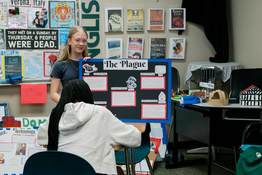 student presenting to another student in a classroom