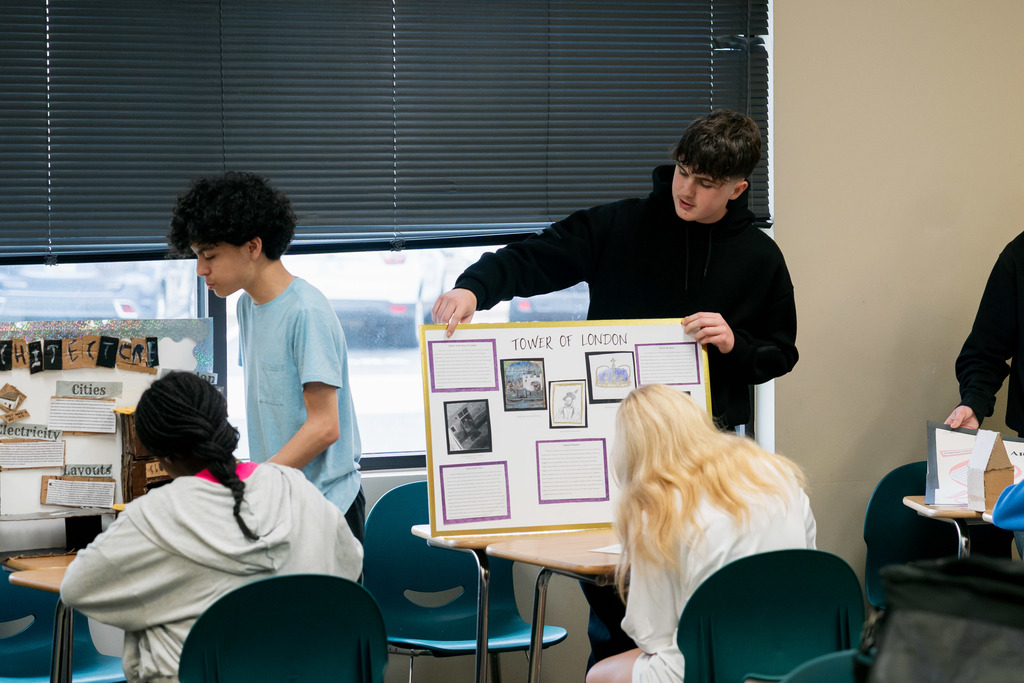 student presenting to another student in a classroom