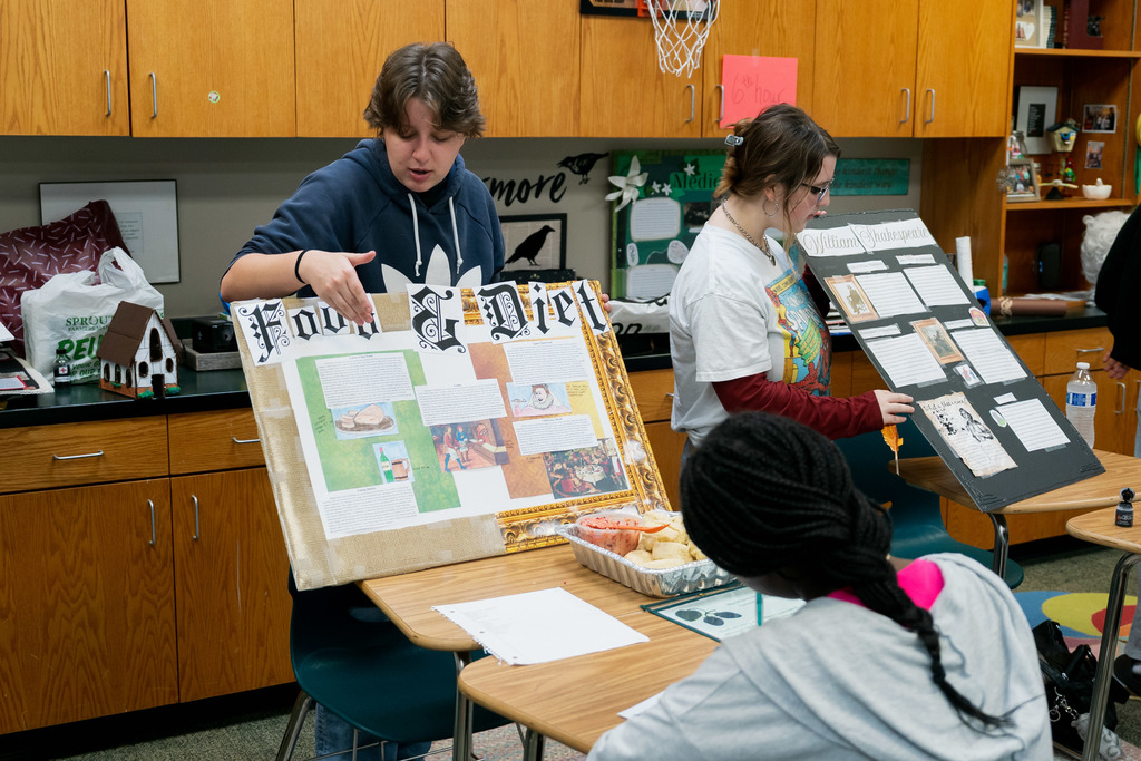 student presenting to another student in a classroom