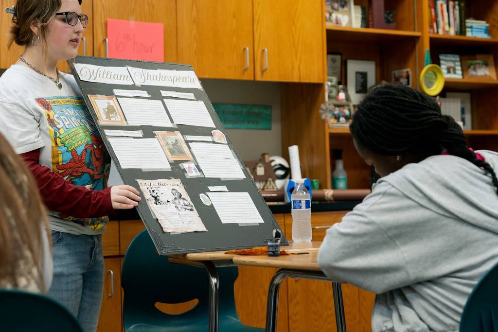 student presenting to another student in a classroom