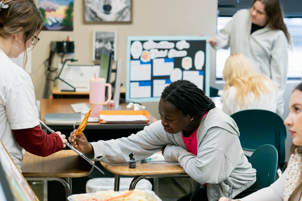 student presenting to another student in a classroom