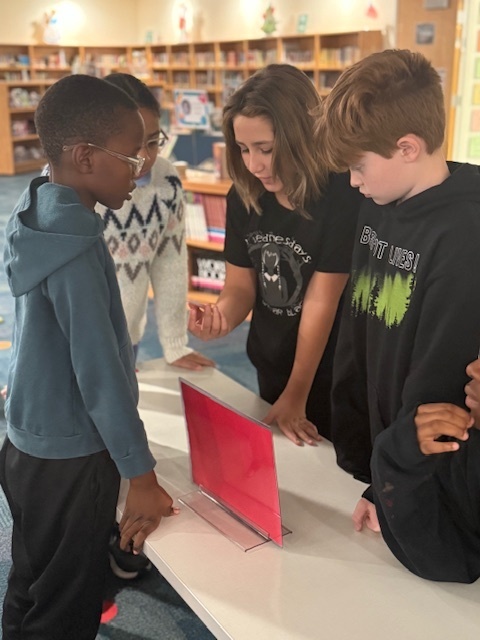 students working on a project in the library