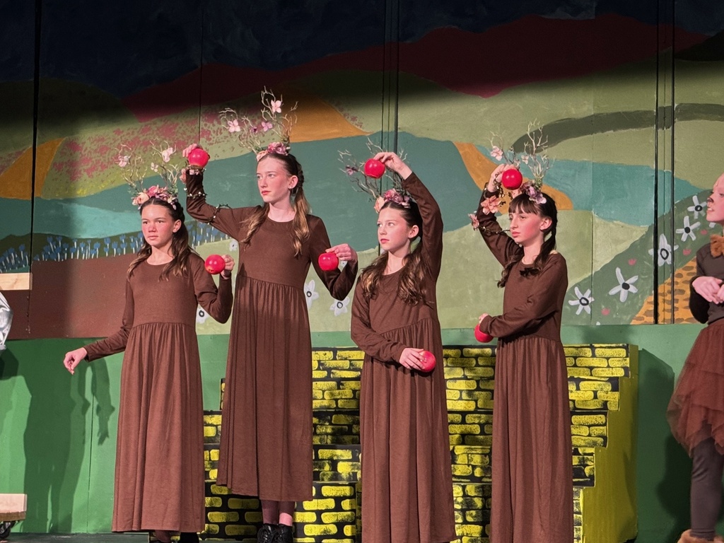 Girls dressed as the talking apple trees from the Wizard of Oz