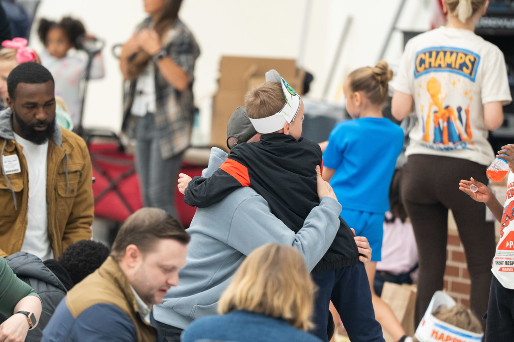 student and parent hugging