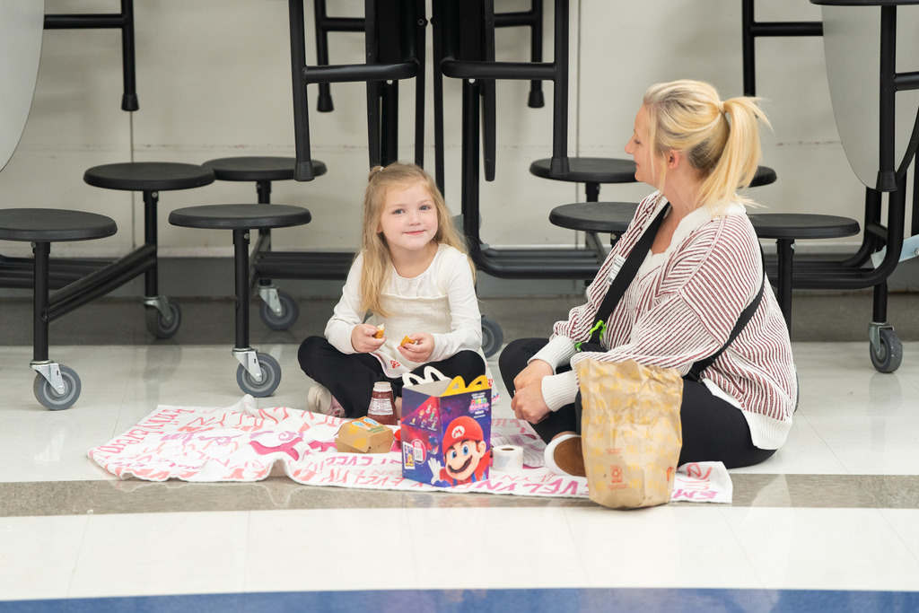 student and parent sitting on the floor