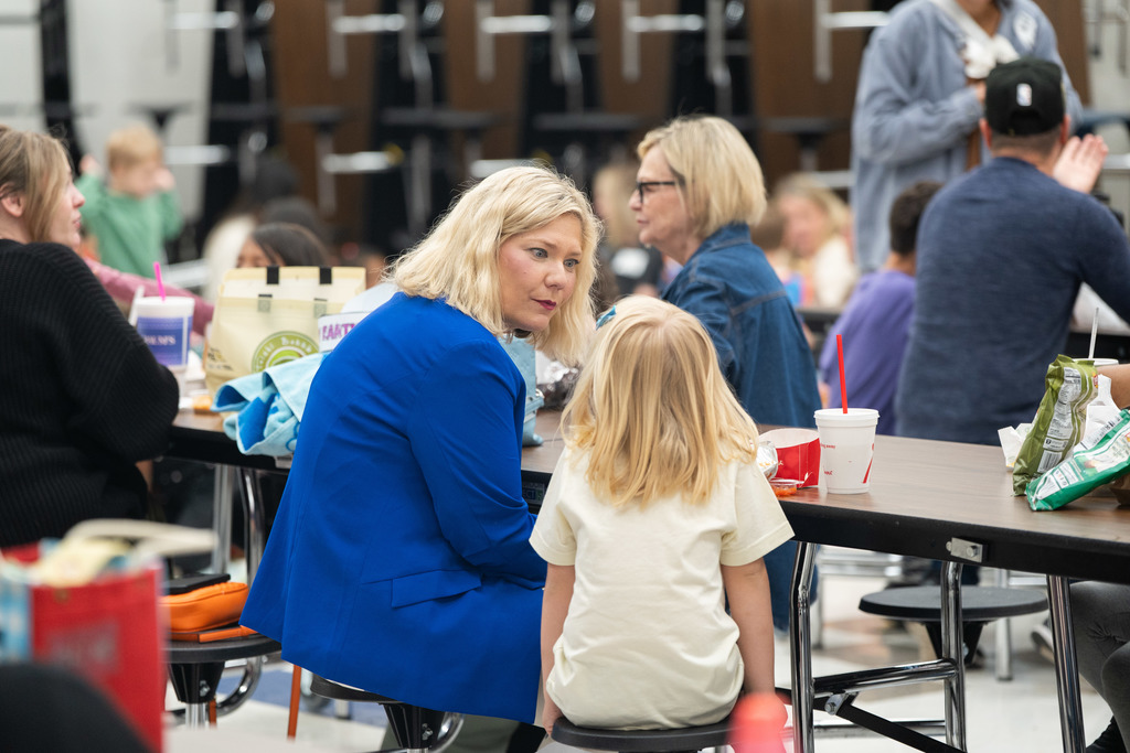 student and parent sitting at a lunch table