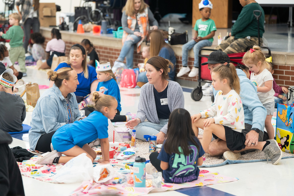 student and parent sitting on the floor