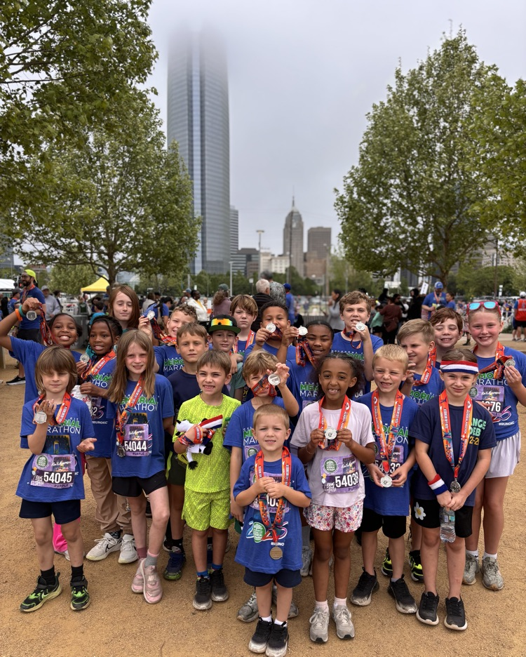 students with medals in front of the Devon tower 