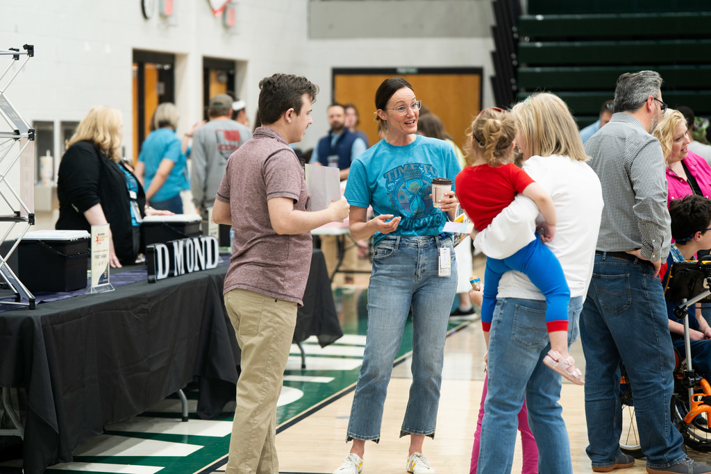 adults and kids talking in a group
