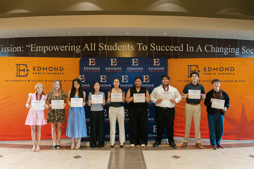 award winners standing with their awards
