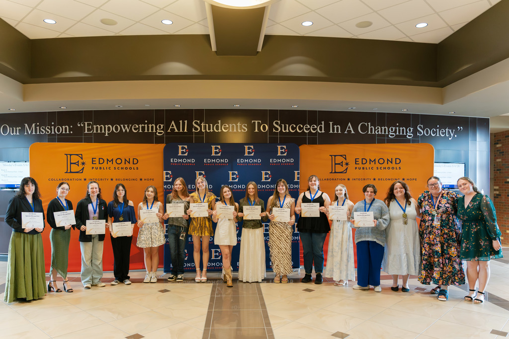 award winners standing with their awards