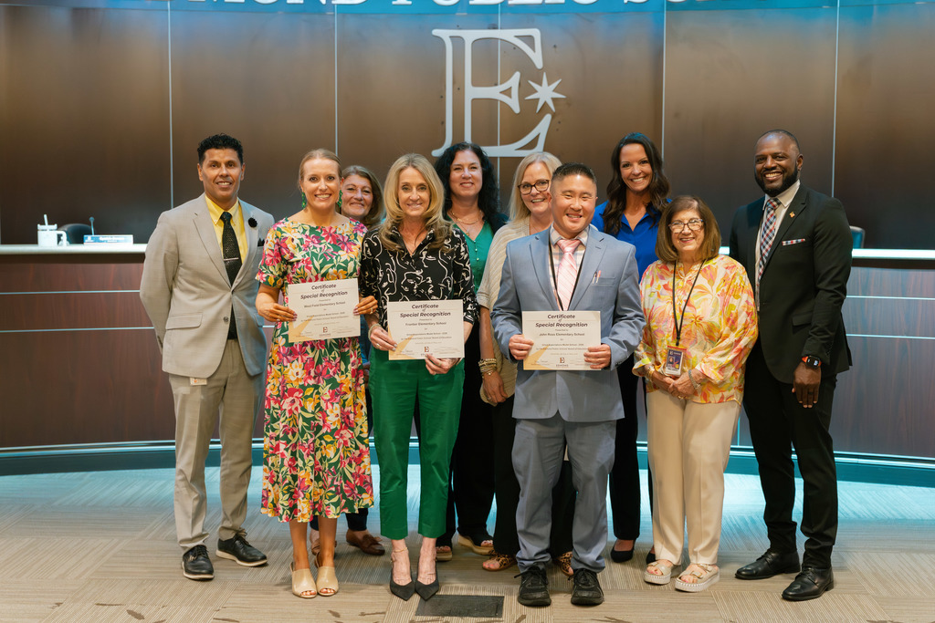 award winners standing with their awards