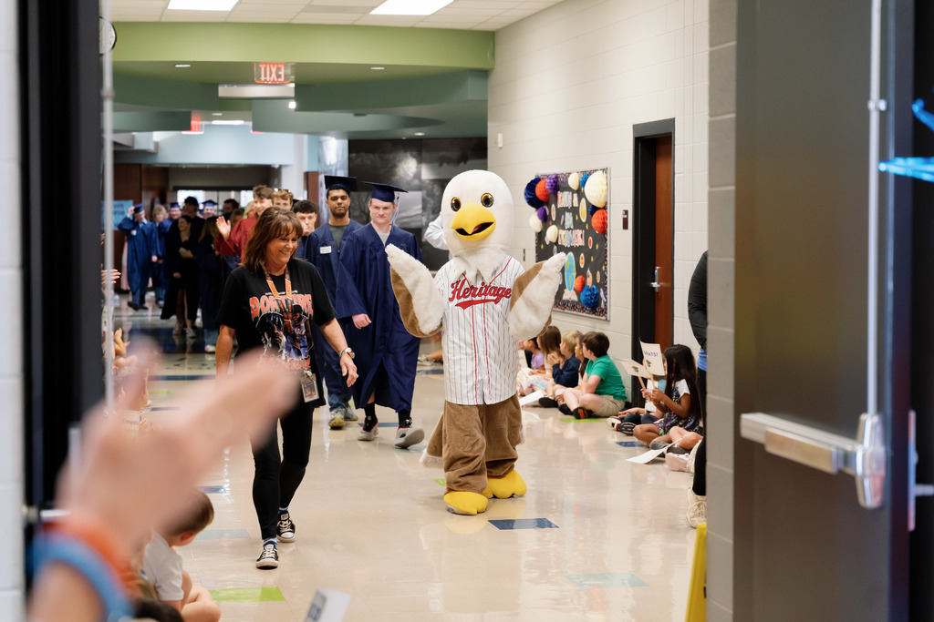 students walking halls with caps and gowns