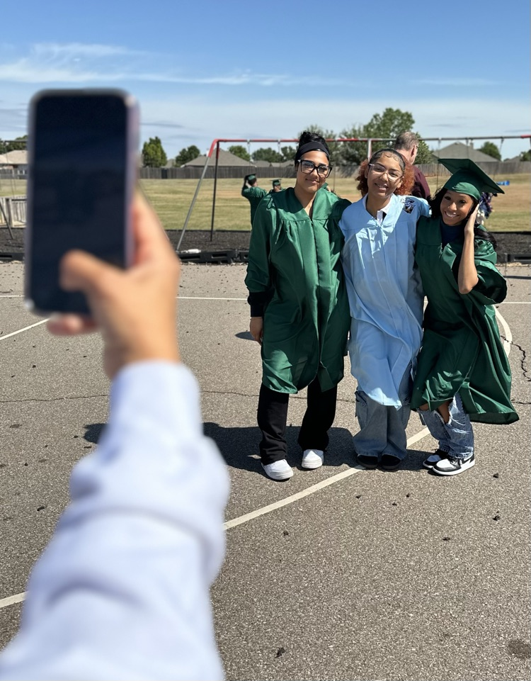 mom taking a picture of group of senior friends 