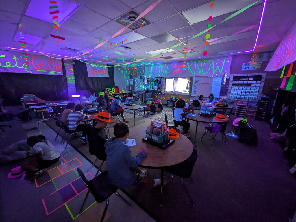 students reading in the dark for "Glow What You Know"