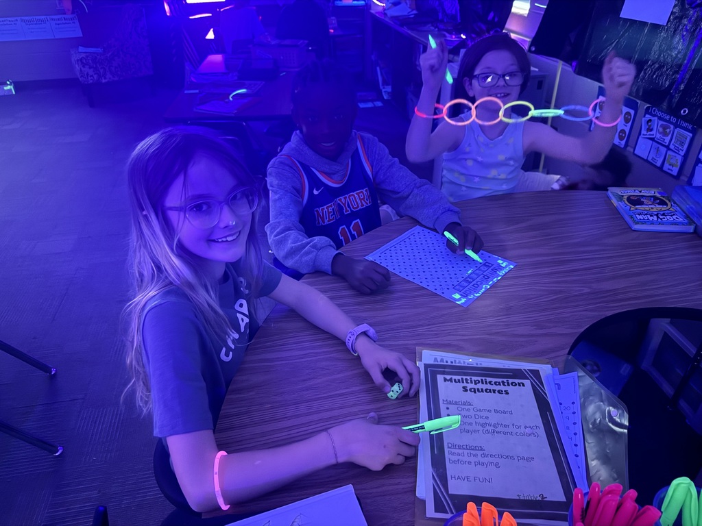 students reading in the dark for "Glow What You Know"