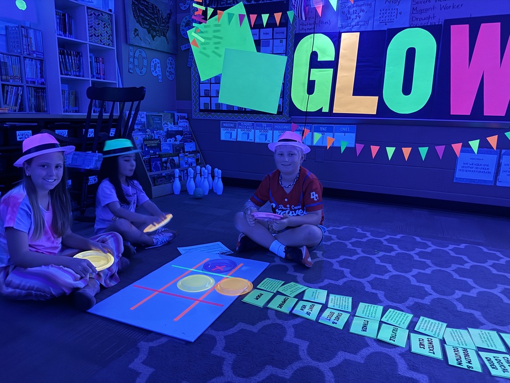 students reading in the dark for "Glow What You Know"