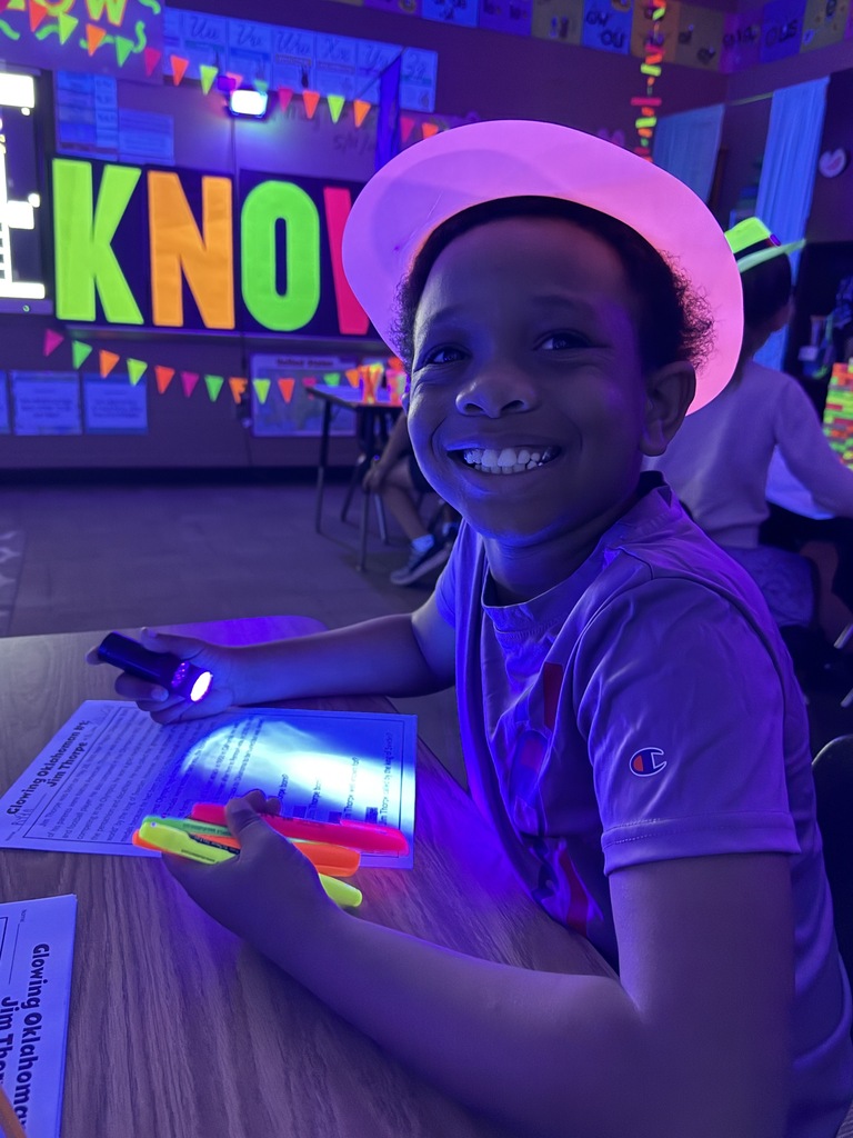 students reading in the dark for "Glow What You Know"