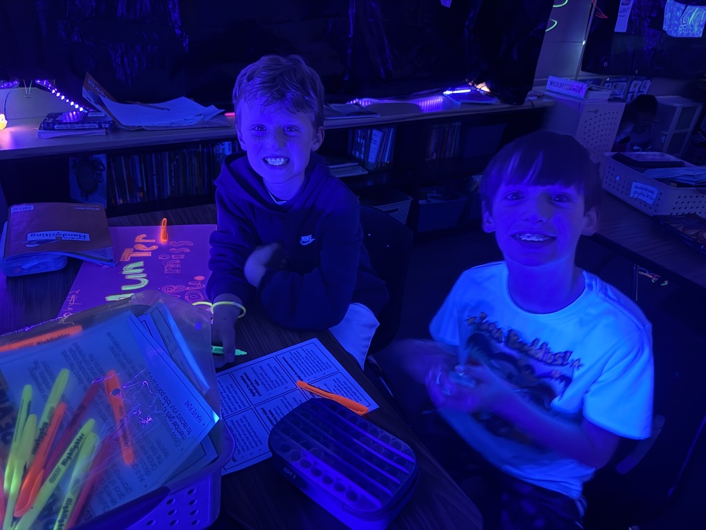 students reading in the dark for "Glow What You Know"