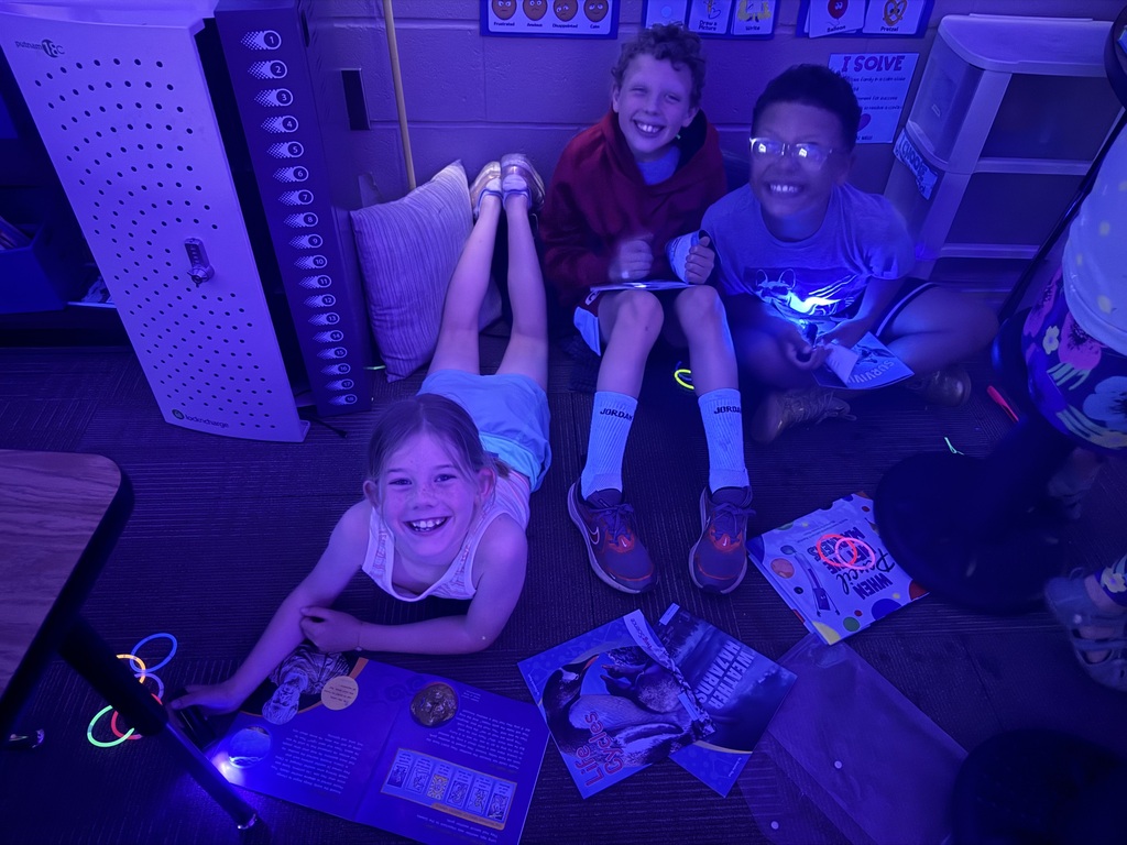 students reading in the dark for "Glow What You Know"