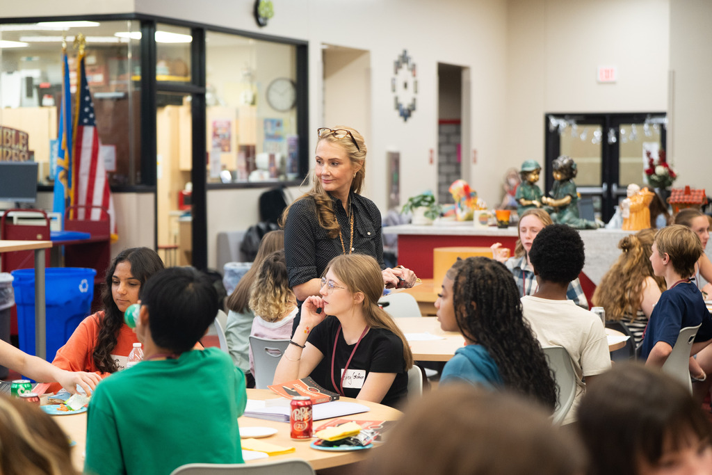 teacher listening to students talk
