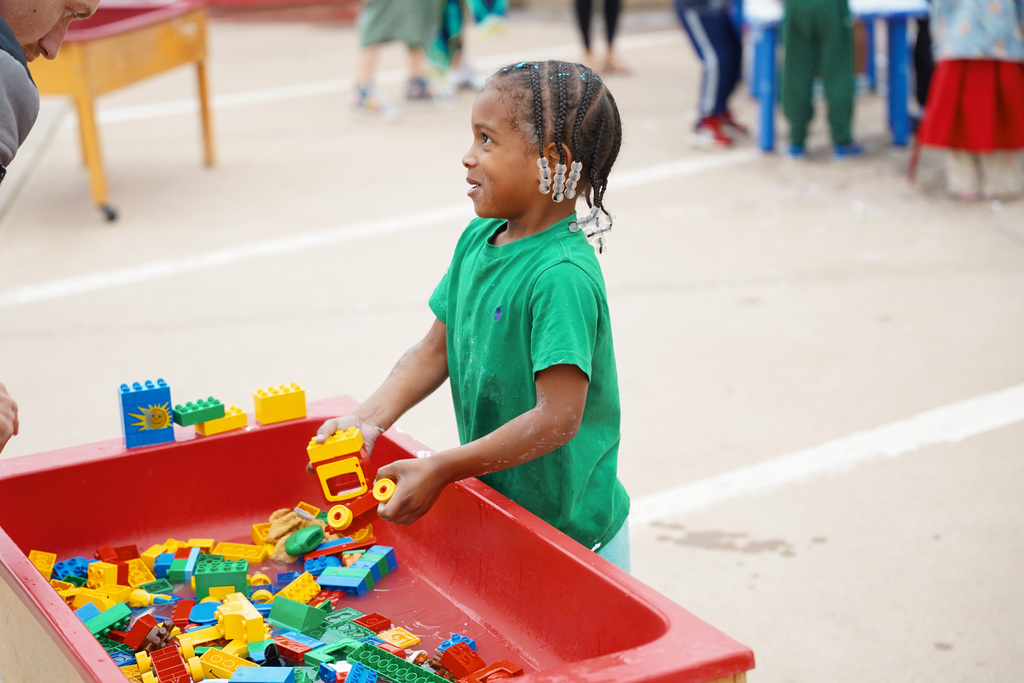 young student playing with tools