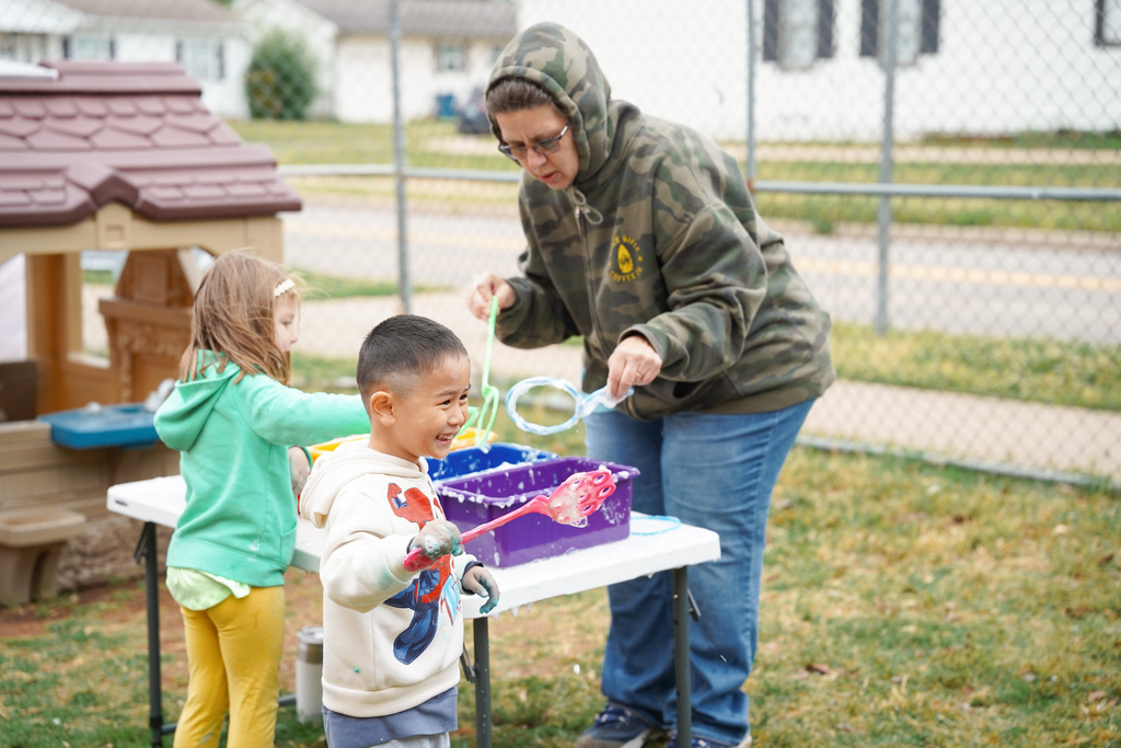 young student playing with bubbles