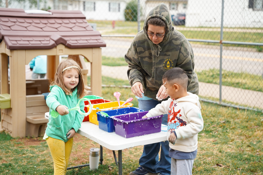 young student playing with bubbles