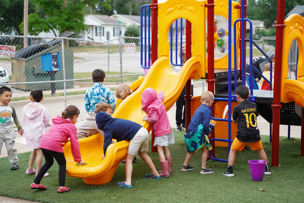 young students playing with sponges