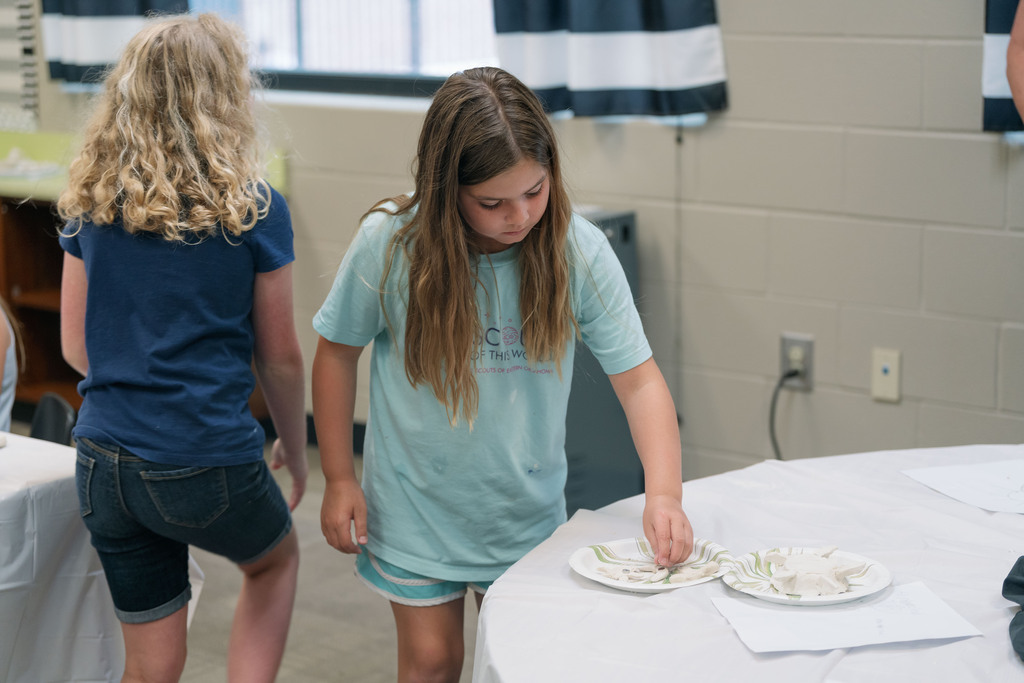 student pointing on a table