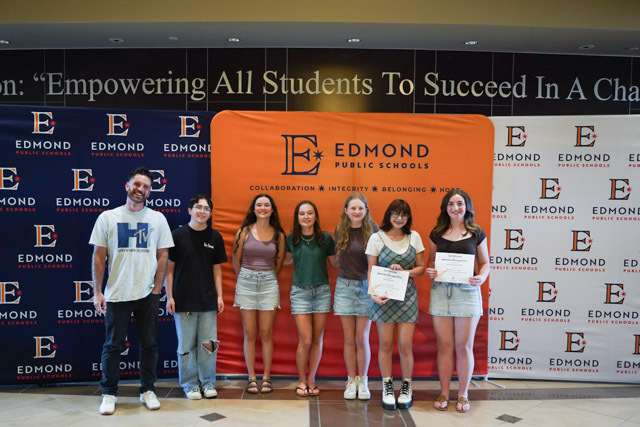 students standing with their awards