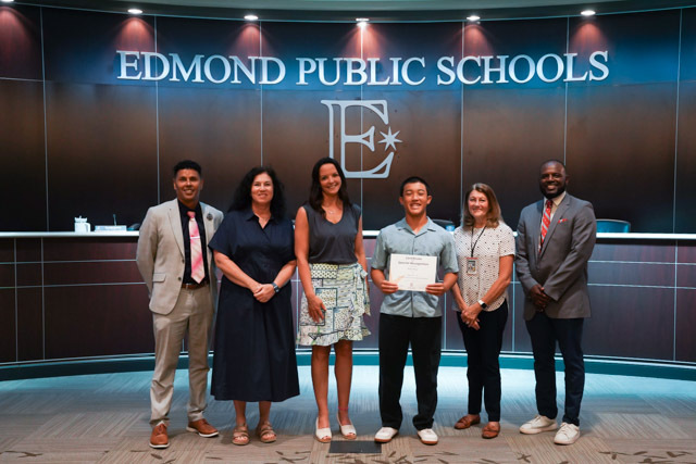 students standing with their awards