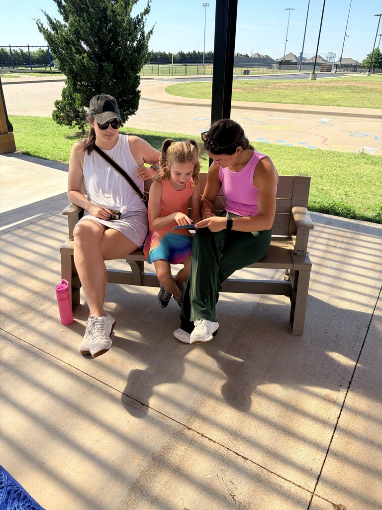 Students/parents/teachers reading at Books & Buddies summer event.