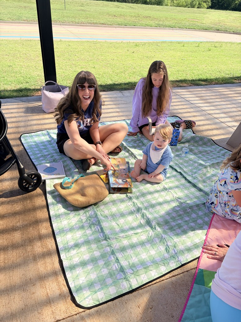 Students/parents/teachers reading at Books & Buddies summer event.