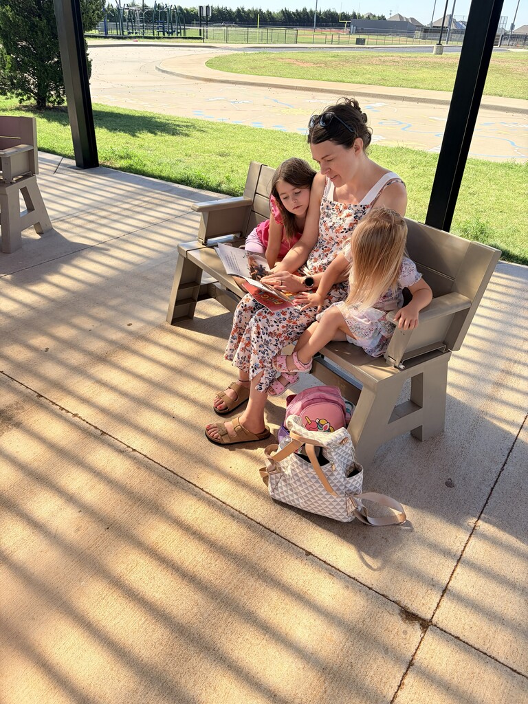 Students/parents/teachers reading at Books & Buddies summer event.