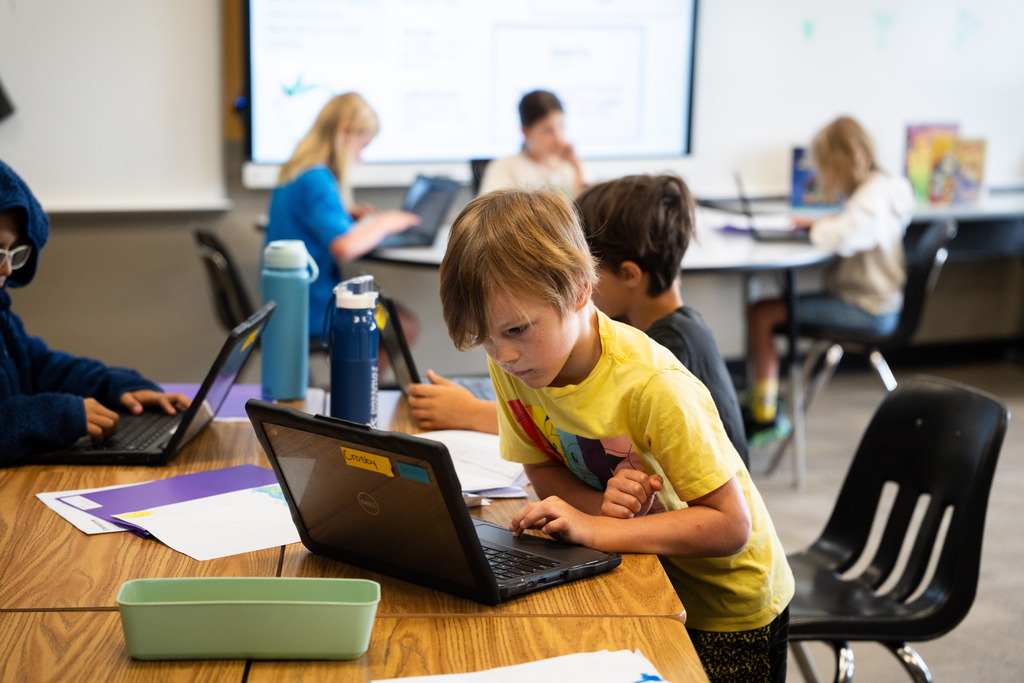 students working on their books on their chromebooks