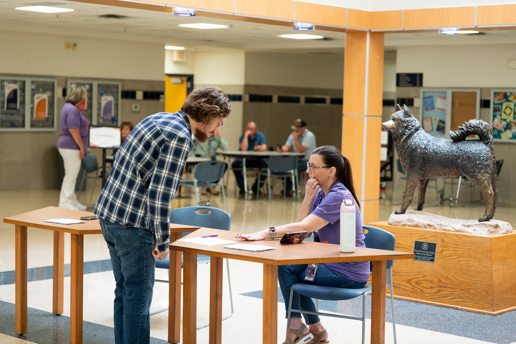 man checking in at a table