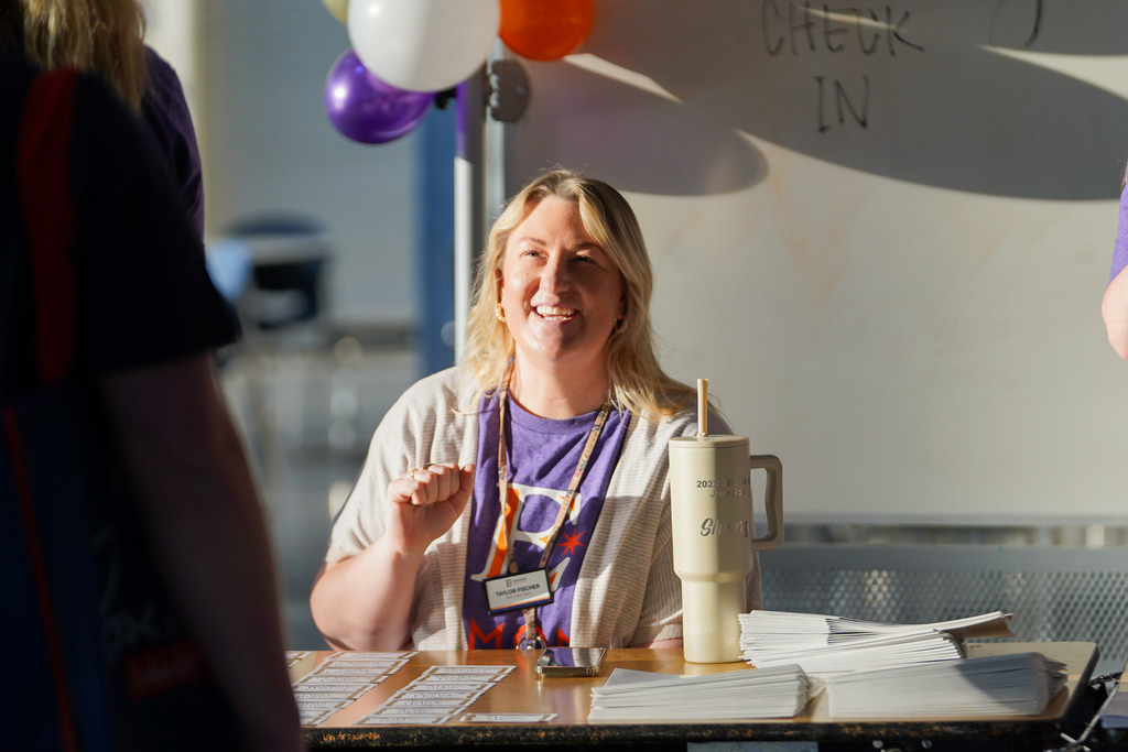 woman checking someone in and smiling