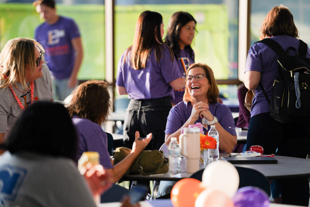 women talking and laughing at a table