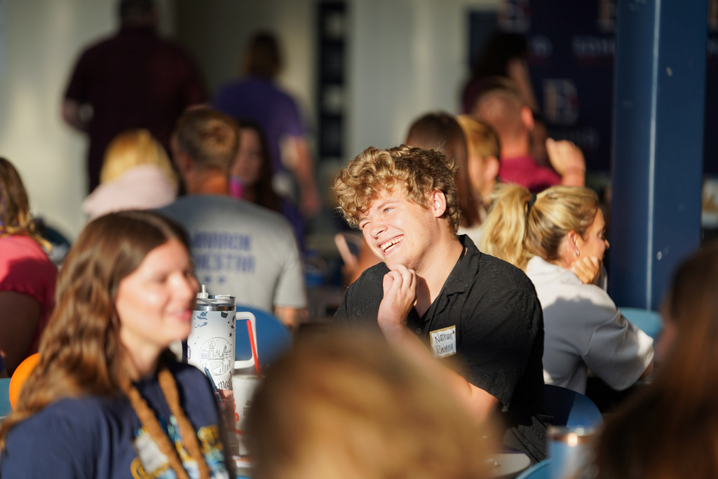 man smiling at a table