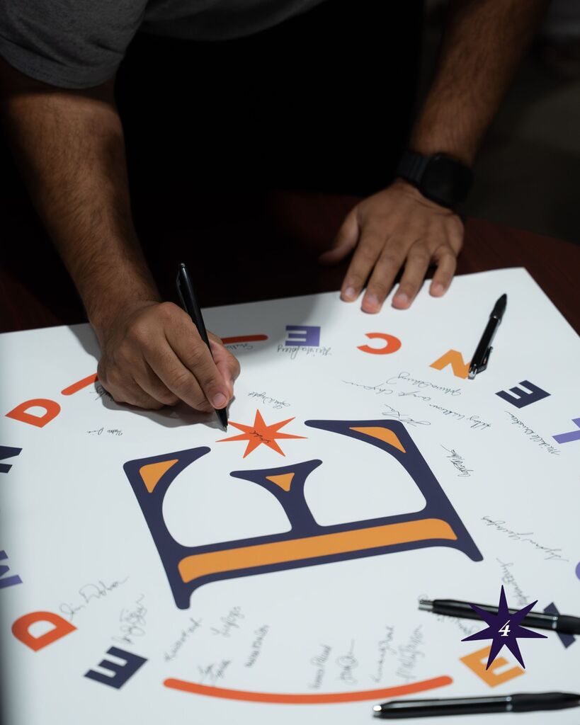 man signing a paper