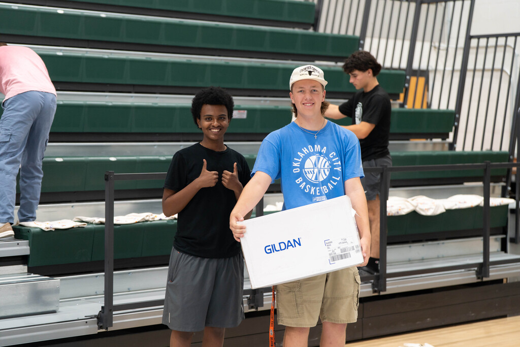 students helping distribute shirts
