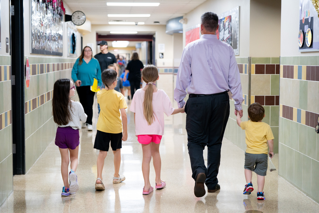 students and parent walking