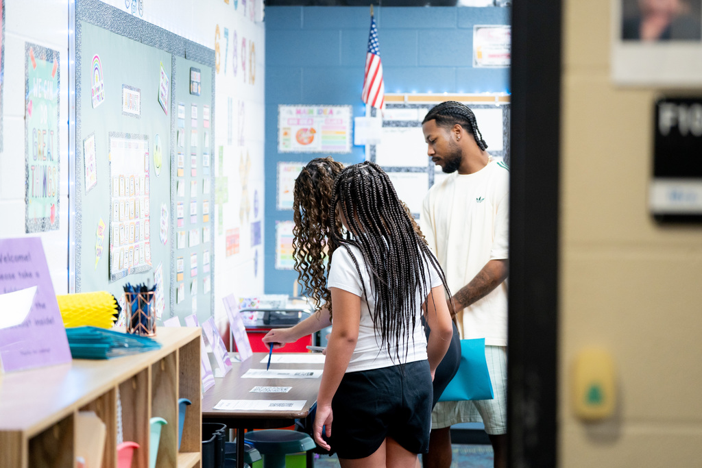 students and parents exploring classroom