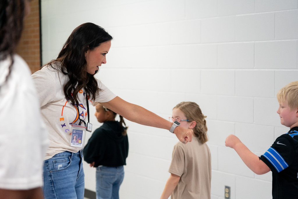 board member giving a student a fist bump