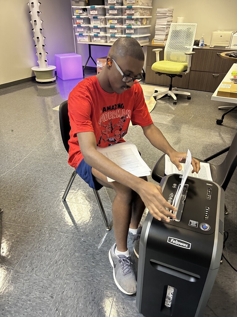 An intern shredding documents. 