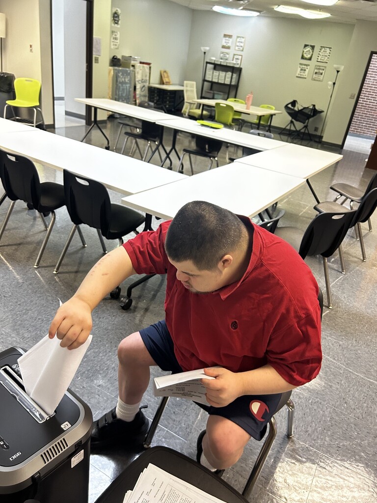 An intern shredding documents. 
