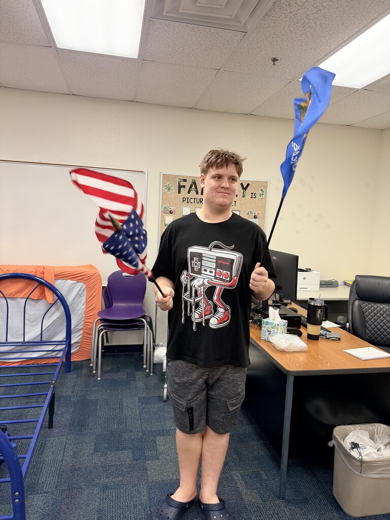 Intern installing classroom flags. 