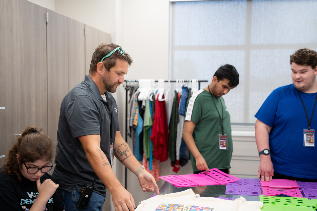 interns and teacher folding clothes